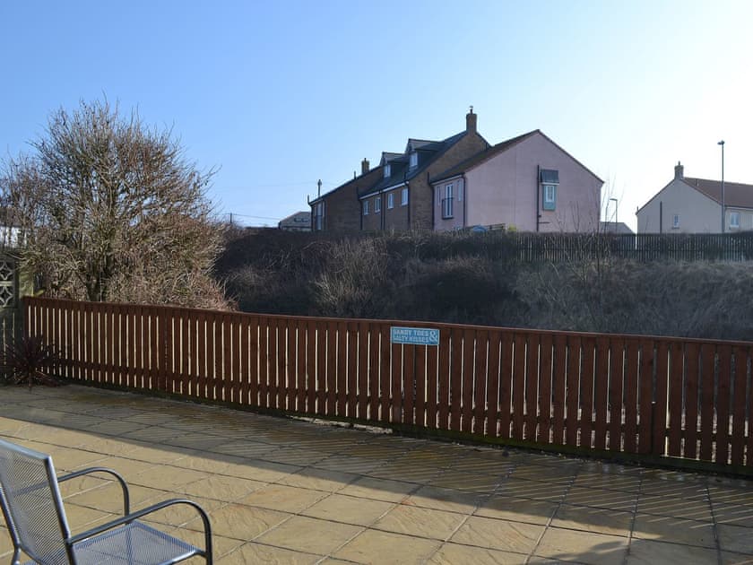 Enjoy the view of the lake and the wildlife from the patio | Longstone Bungalow, Beadnell
