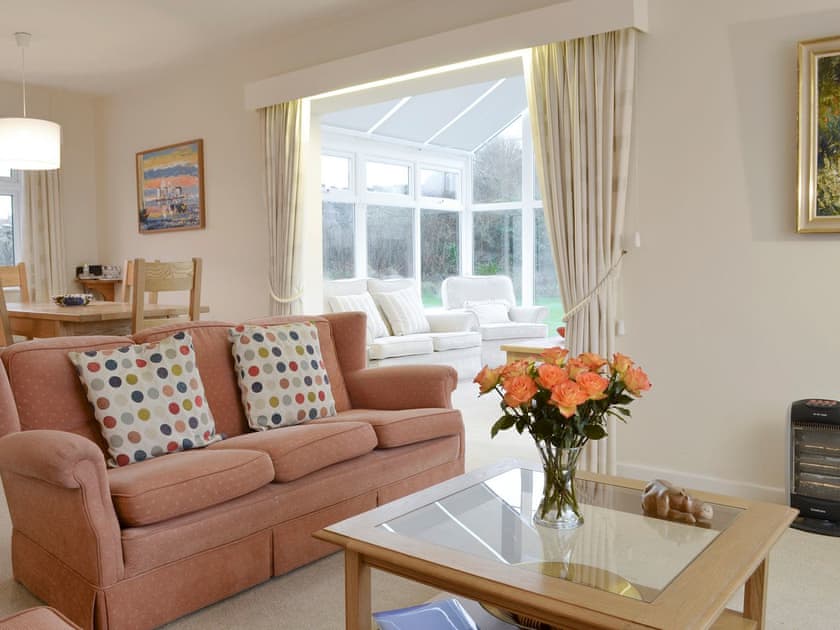 Large living and dining room with open aspect to conservatory | Craigneish Bungalow, Trearddur Bay, near Holyhead