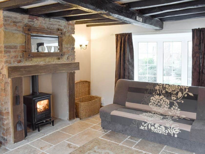 Exposed wood beams and feature fireplace in living room | Listers Lodge, Brotton, near Saltburn-by-the-Sea