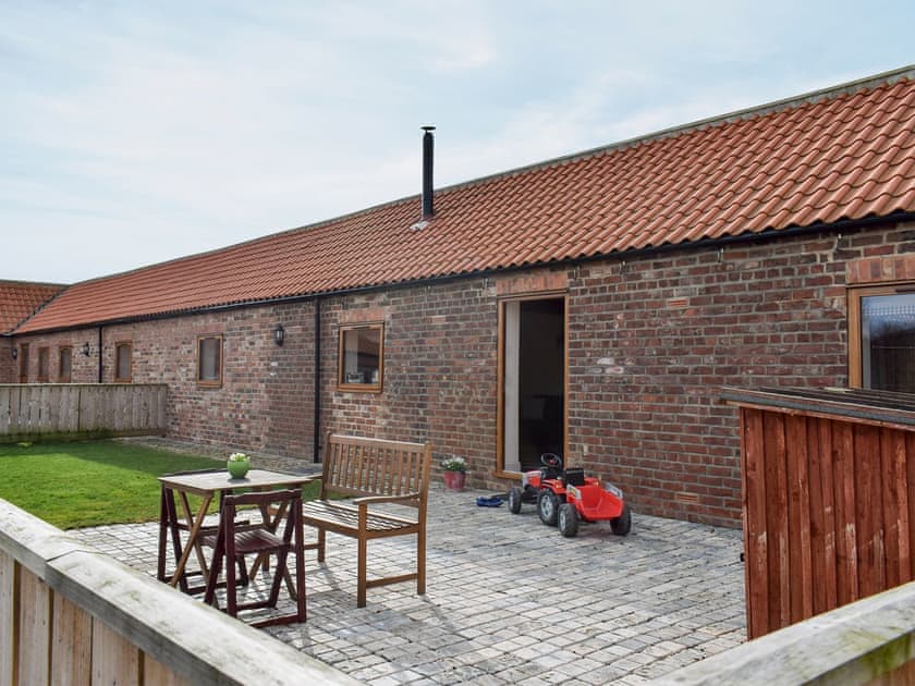 Enclosed garden with patio and garden furniture | Rupert’s Stable - Cleveland View Cottages, Easby Grange, near Great Ayton