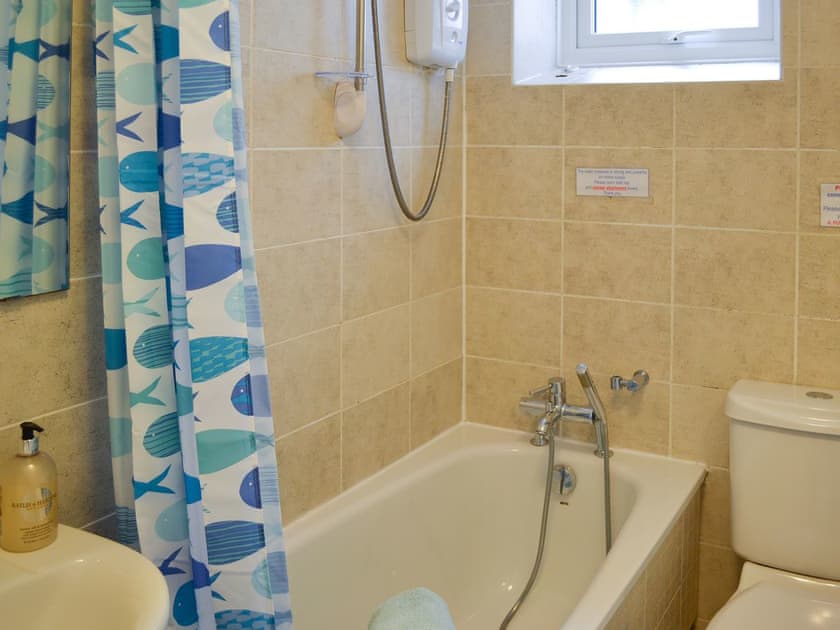 Tiled bathroom with shower attachment and shower over bath | Salty Cottage, Newlyn, near Penzance