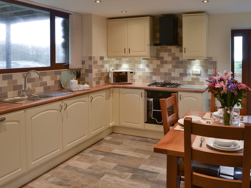 Well equipped kitchen and dining area | Stabal Arthur - Trehwfa Cottages, Bodedern, near Holyhead