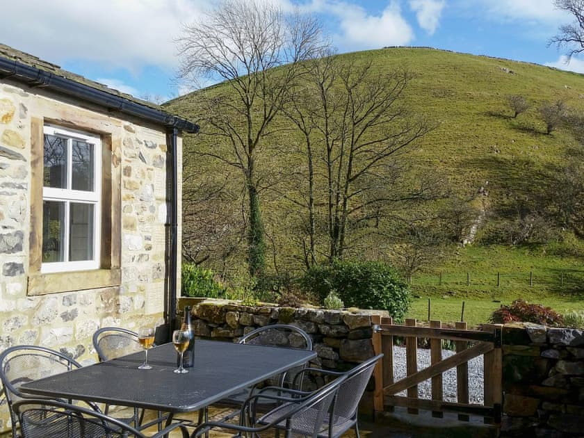 Enclosed patio with garden furniture | Miller Cottage, Scalegill, near Kirkby Malham