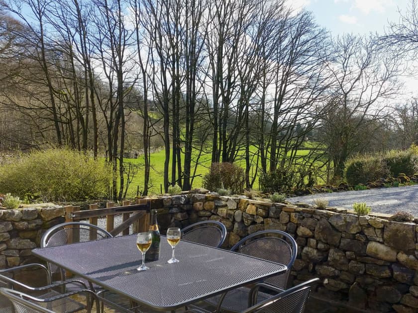 Enclosed patio with garden furniture | Miller Cottage, Scalegill, near Kirkby Malham