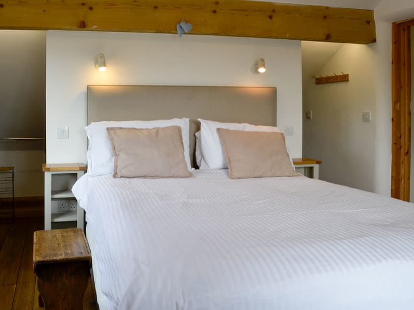 Double bedroom with kingsize bed and beams | Bryn Gwnog, Llanrwst, near Betws-y-Coed
