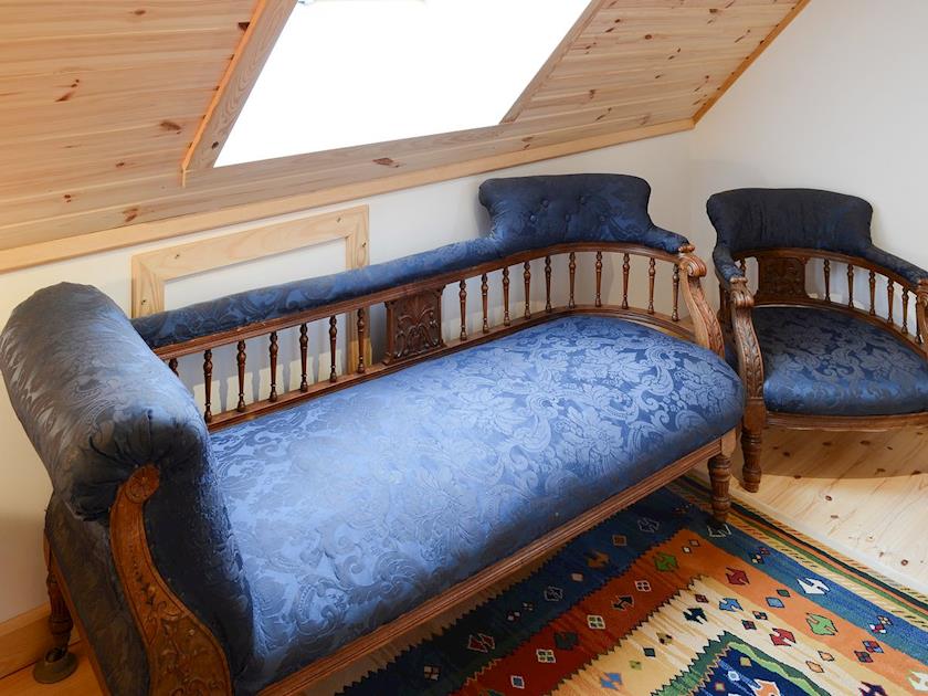The landing is home to a comfortable chaise longue | Fionn Croft Lodge, Melvaig, near Gairloch