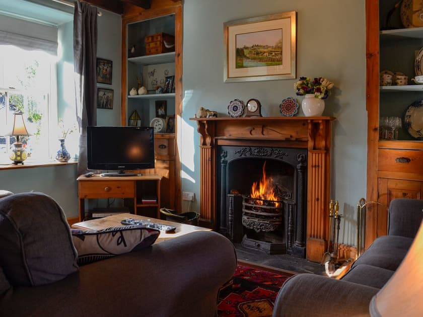 Cosy living room with open fire | Gwernol, Dolwyddelan, near Betws-y-Coed