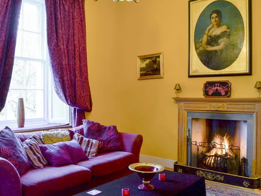 Open fire in the characterful living room | Lochside Garden House - Lochside, Town Yetholm, near Kelso