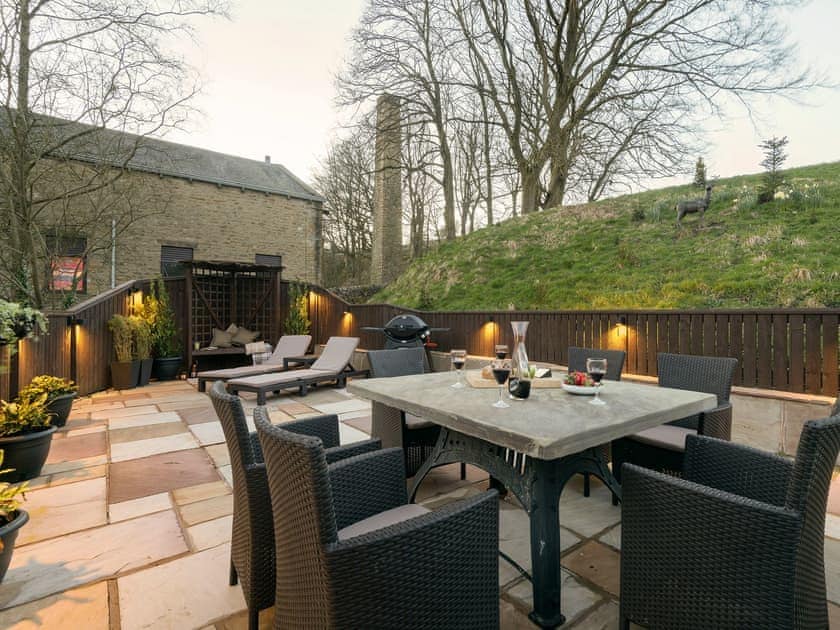 Outdoor eating area of the patio with evening illumination | Narrowgates Cottage, Barley, near Barrowford