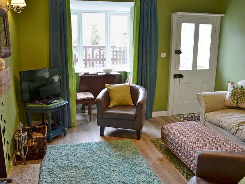 Warm and welcoming living room with wood burner | Nutmeg Cottage, Tideswell, near Buxton