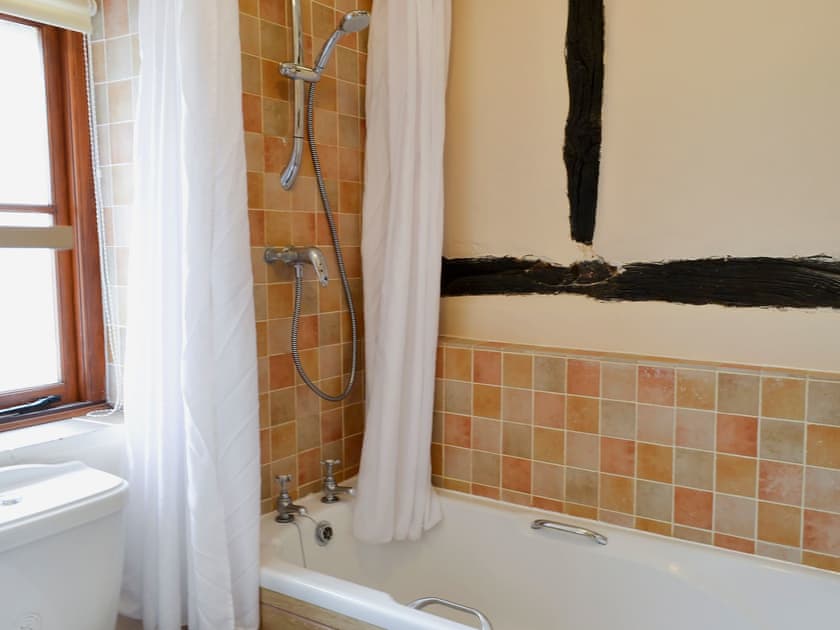 Bathroom with shower over bath | Tudor Cottage Studio - Tudor Cottages, Romsey