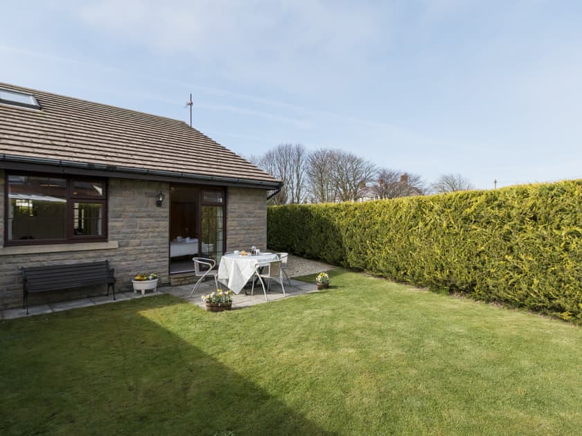 Enclosed lawned garden with sitting-out area and furniture | Cleet’s Retreat, Seahouses