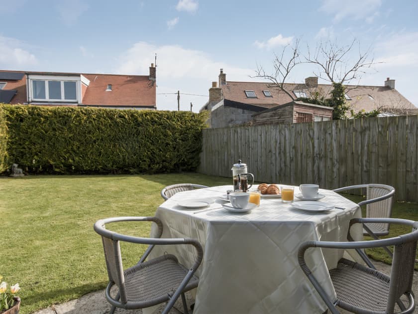 Enclosed lawned garden with sitting-out area and furniture | Cleet’s Retreat, Seahouses