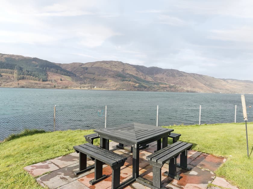 Sitting-out-area set right on the shore  | Loch Duich Cottage, Inverinate, by Kyle