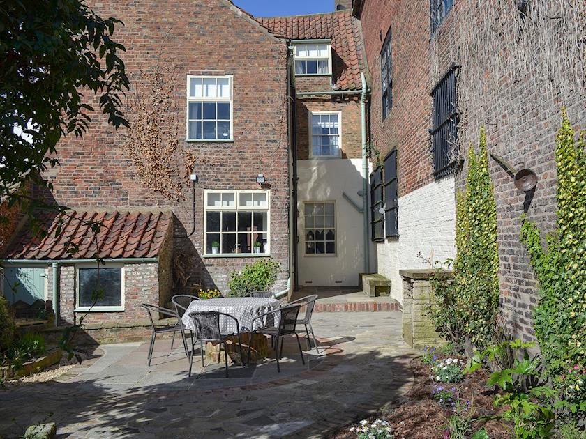 Private courtyard with table and chairs for al-fresco dining | Nell’s Cottage, Bridlington