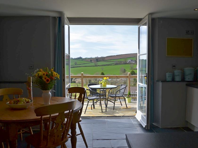 Kitchen/dining area with French doors leading to balcony | The Old Classroom, St Neot, near Liskeard