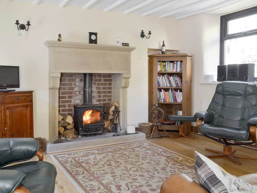 Stylish living area with feature fireplace | Poppy Cottage, Bonsall, near Matlock