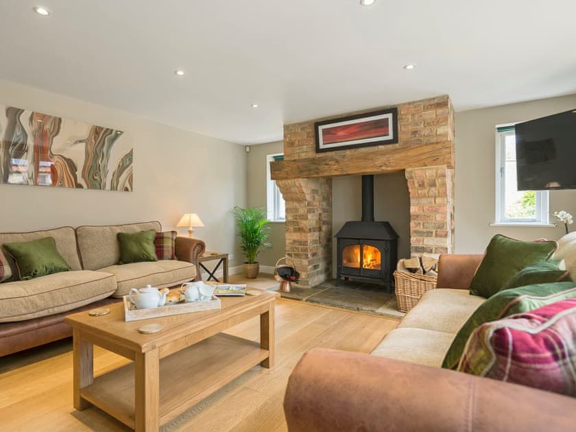 Stylishly furnished living room with wood burner | The Stables, Aisby, near Grantham