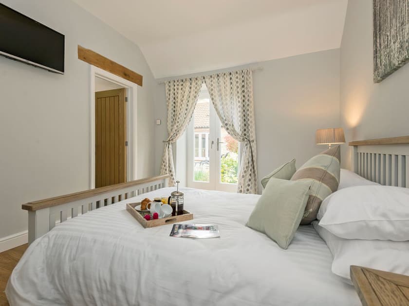 Elegantly decorated double bedroom with kingsize bed | The Stables, Aisby, near Grantham