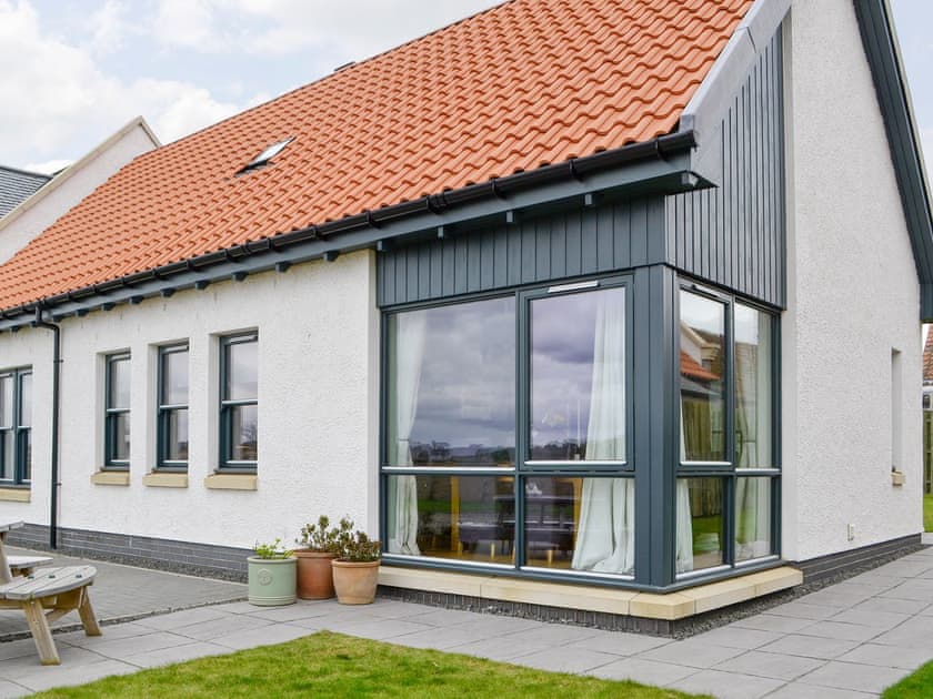 Rear of property with paved path and patio | Strathspey - Paddockhall Cottages, Linlithgow, near Edinburgh 