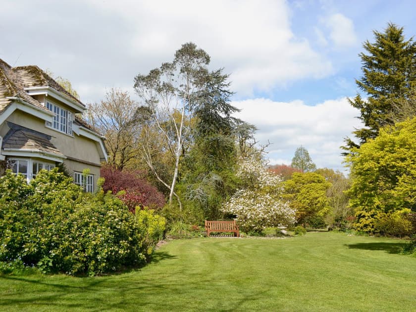 Shared enclosed small lawned garden with patio and furniture | Burrow Farm Garden Retreat - Valley View - Burrow Farm Gardens Retreat, Dalwood, near Axminster