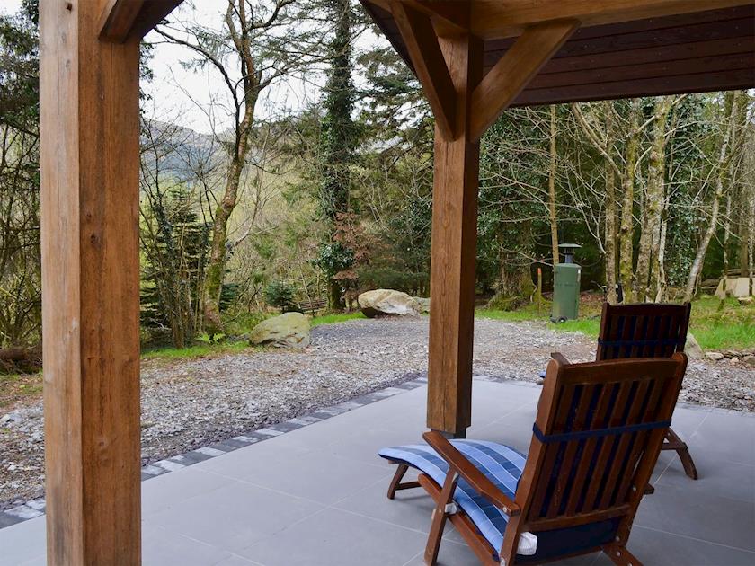 Patio with furniture and woodland views | Glan-y-Gors, Beddgelert
