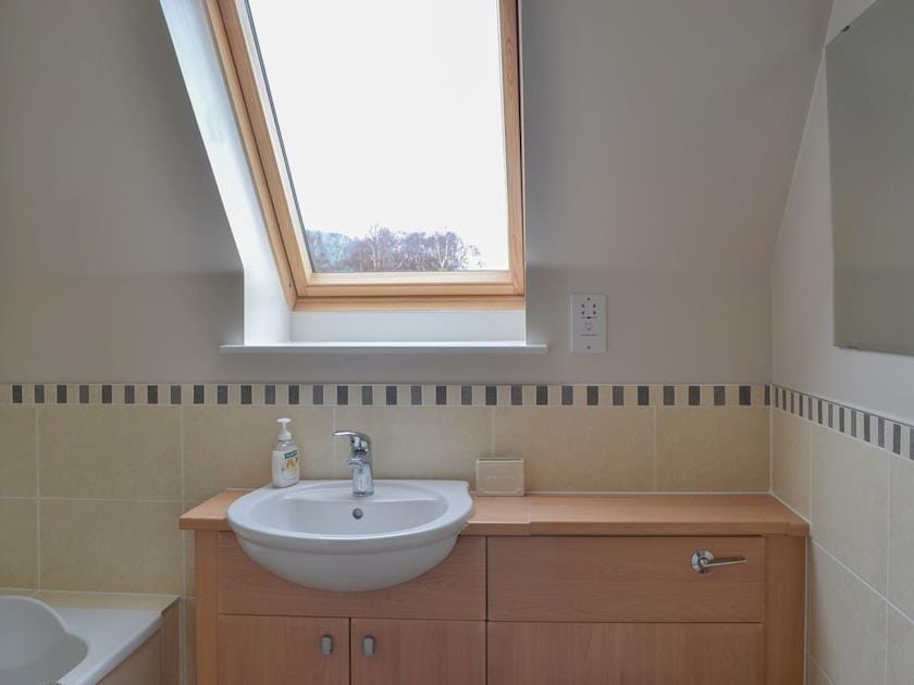 Lovely bathroom with heated towel rail and shower over bath | Stags Neuk, Aviemore
