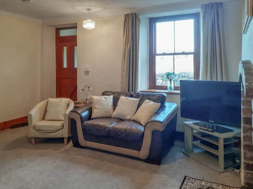 Welcoming living room with wood burner | Bettws y Gwynt, Llanbedrgoch, near Benllech