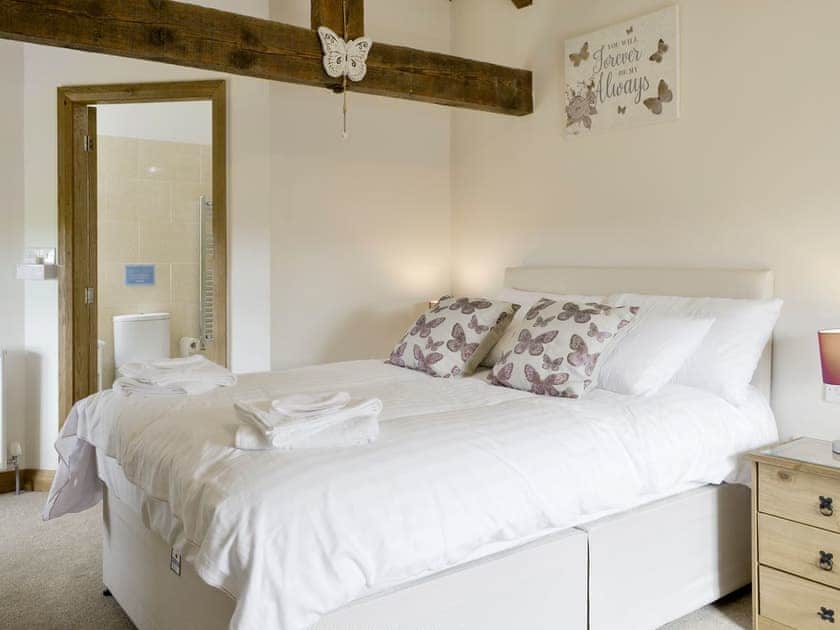 Exposed wood beams in second double bedroom | Llofft Storws - Bronallt Barns, Llanynghenedl, near Holyhead