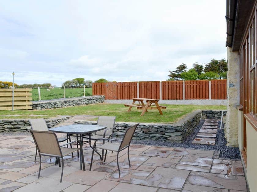 Patio with outdoor furniture | Llofft Storws - Bronallt Barns, Llanynghenedl, near Holyhead