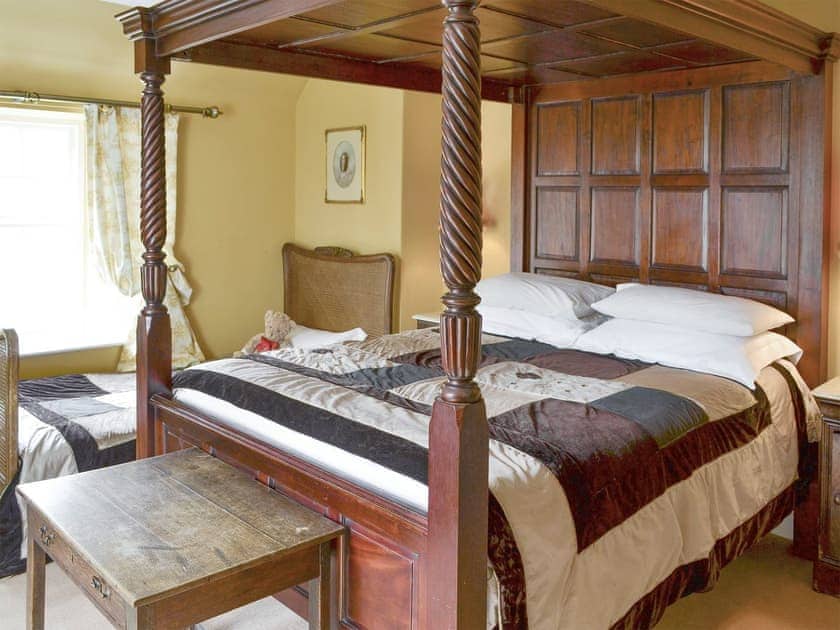 Family bedroom with a four poster and a single bed | Lochside Garden House - Lochside, Town Yetholm, near Kelso