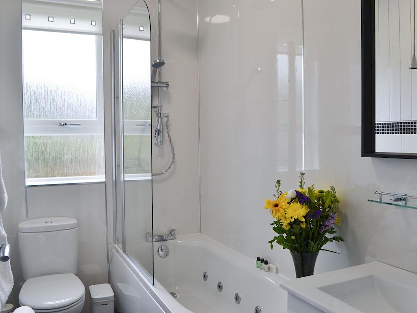 Bathroom with spa bath and shower over the bath | Rocky Mountain View, Glencoe