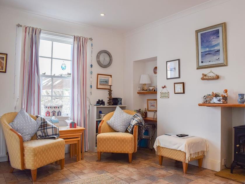 Tile-floored open plan living area with electric wood burner | Fidra, Anstruther