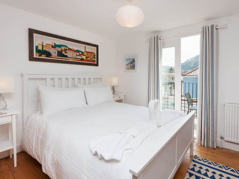 Kingsize bedroom with French doors to balcony | Kitcat Cottage, Dartmouth