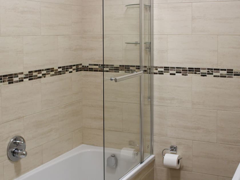 Tiled bathroom with shower over the bath | The LandingsApartment 2, Filey