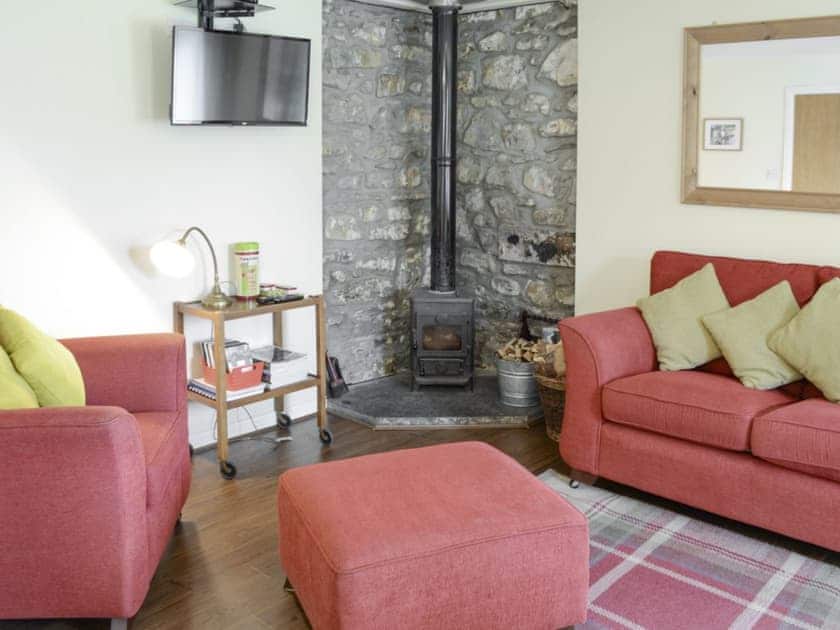 Warm and welcoming living area with wood burner | Birch Cottage - Glenrossal Cottages, Rosehall, near Lairg