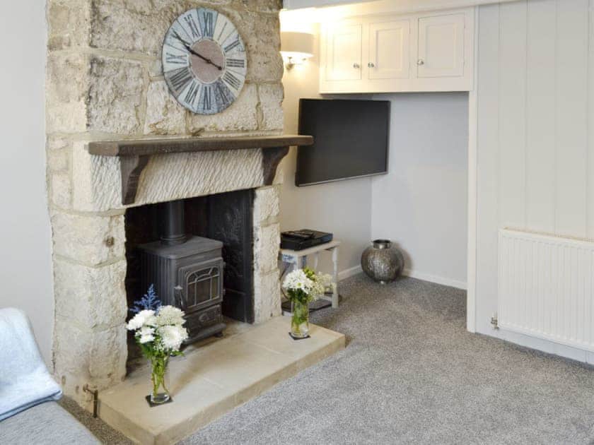 Feature fireplace within living room | Samphire Cottage, Fortuneswell, Portland