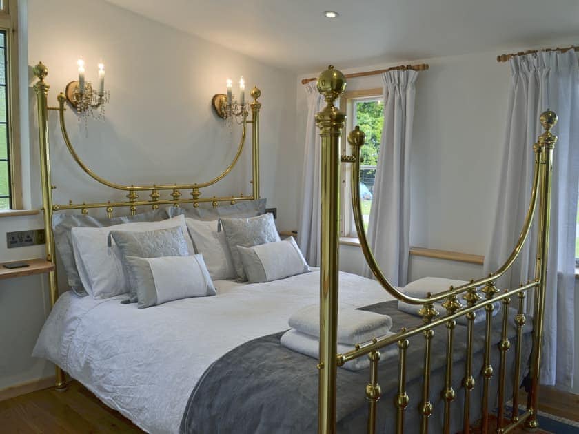 Comfortable bedroom with kingsized brass bed  | The Escape, South Hill, near Tamar Valley