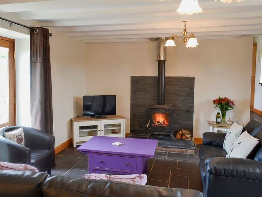 Spacious and warm living room with wood burner | Yr Hen Feudy - Bronallt Barns, Llanynghenedl, near Holyhead