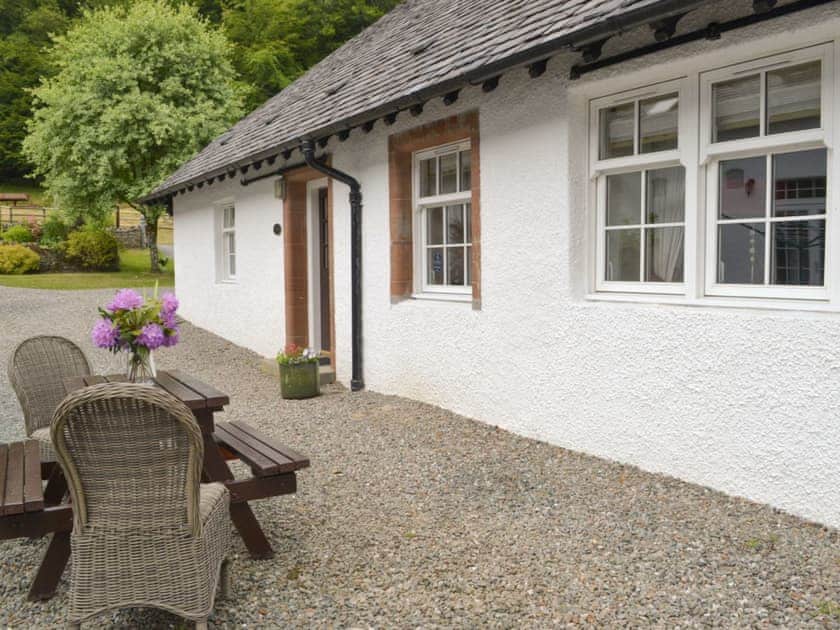 Appealing holiday home with outdoor furniture on gravelled patio area | Stables Cottage - Home Farm, Glendaruel