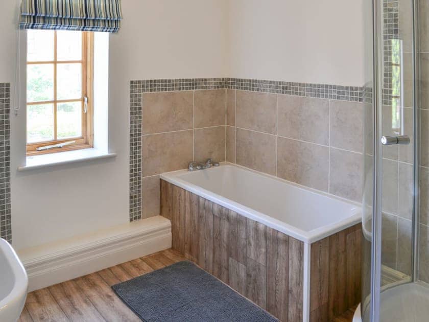 Lovely bathroom with shower cubiv=cle and bath | Three The Boulevard, Sheringham