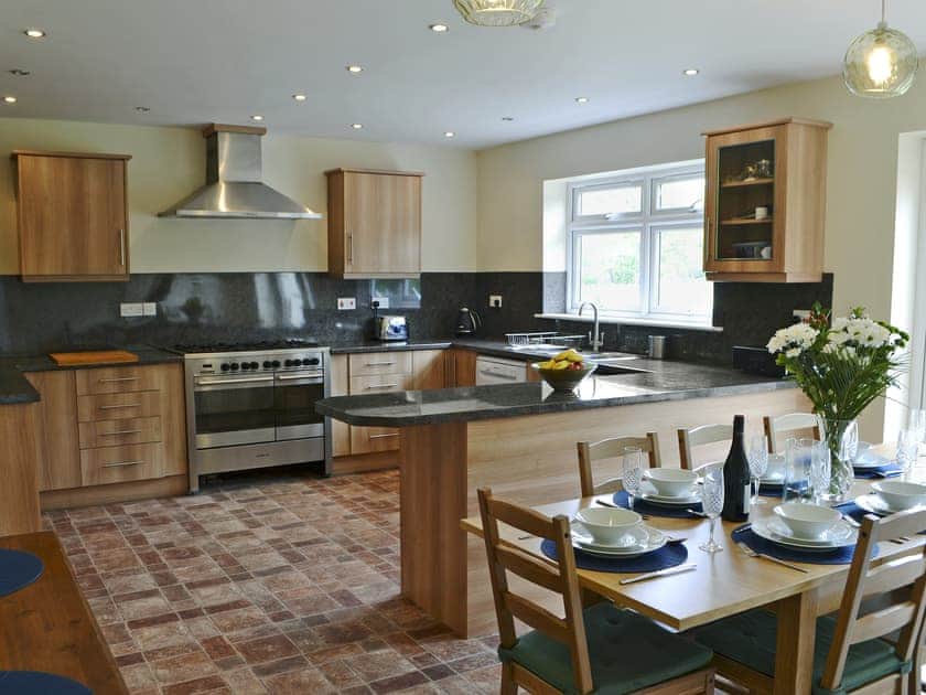 Spacious kitchen/dining room with French doors to patio | Elm Croft, Falstone, near Bellingham