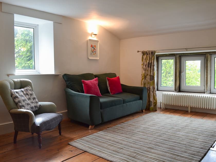 Wooden-floored living area with double sofa bed | Pear Tree House Annexe, Wooldale, near Holmfirth