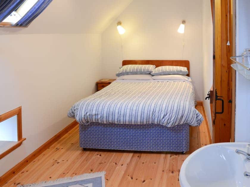 Inviting double bedroom with sloping ceiling | Watermill Cottages - Watermill Cottages, John O’ Groats