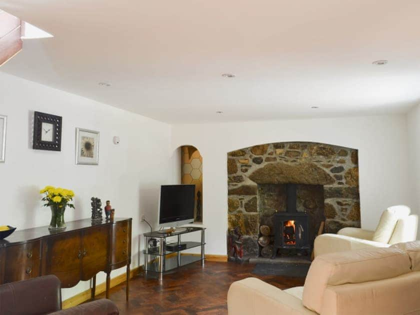 Roomy open plan living space with wooden floors and multi-fuel burner | Woodend, Fort William