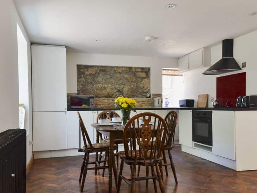 Roomy open plan living space with wooden floors and multi-fuel burner | Woodend, Fort William