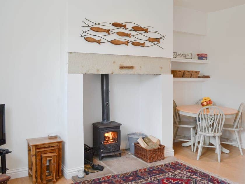 Cosy living area with wood burner | Dipper Cottage, Seahouses