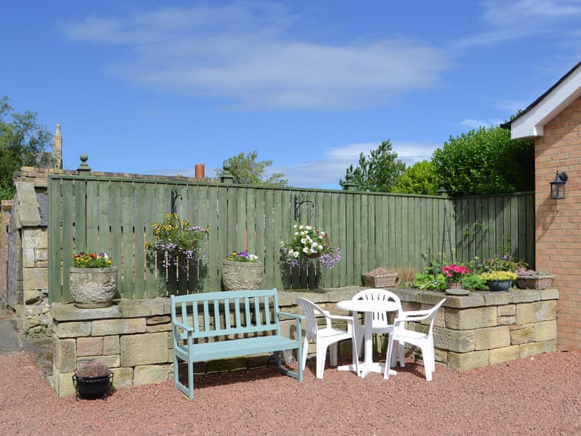 Gravelled patio with outdoor furniture at rear | Barkers Cottage, Ellington, near Druridge