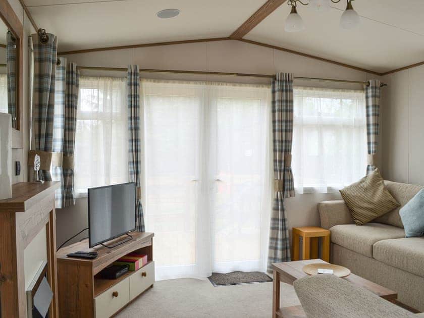Comfortable lounge area with TV | Fir Tree Lodge, Aviemore