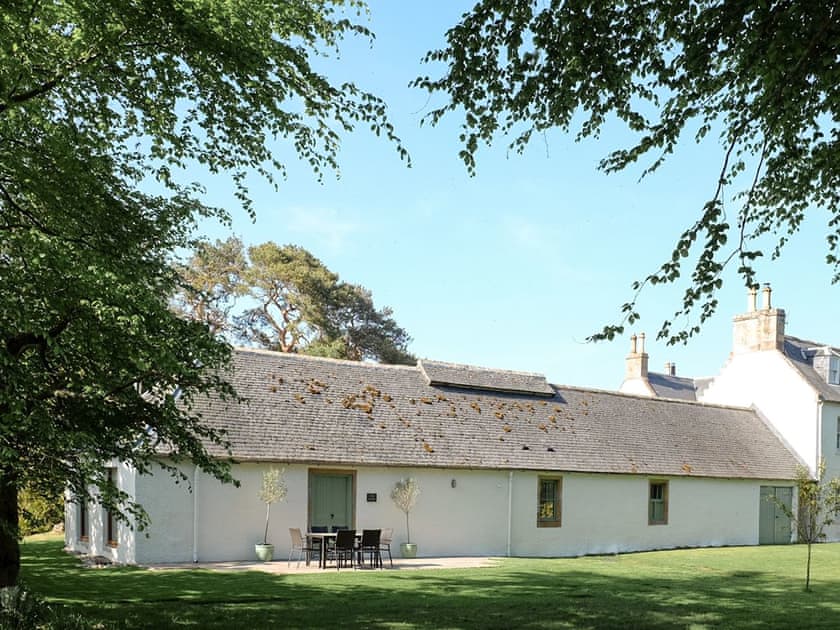 The garden is surrounded by woodland which encourages bird life | The Barn, Kildary, near Tain